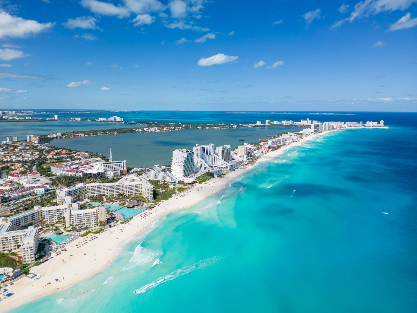 Beautiful aerial view of Cancun's coastline with clear blue waters and luxury resorts.