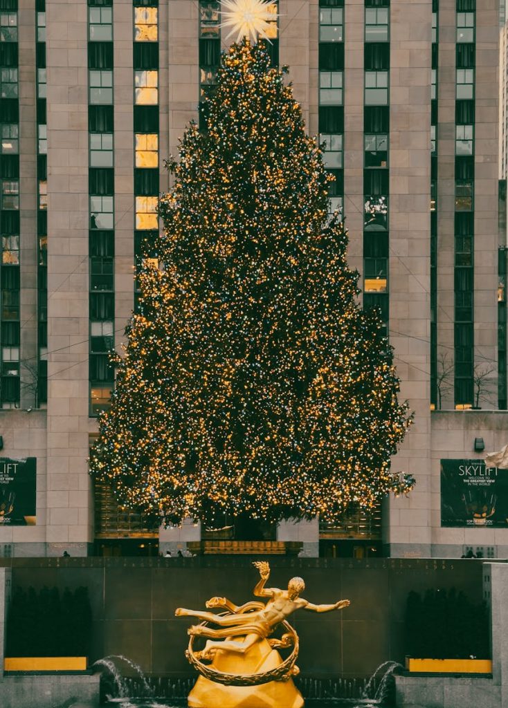 Stunning view of the Christmas tree at Rockefeller Center, New York City, adorned with sparkling lights.