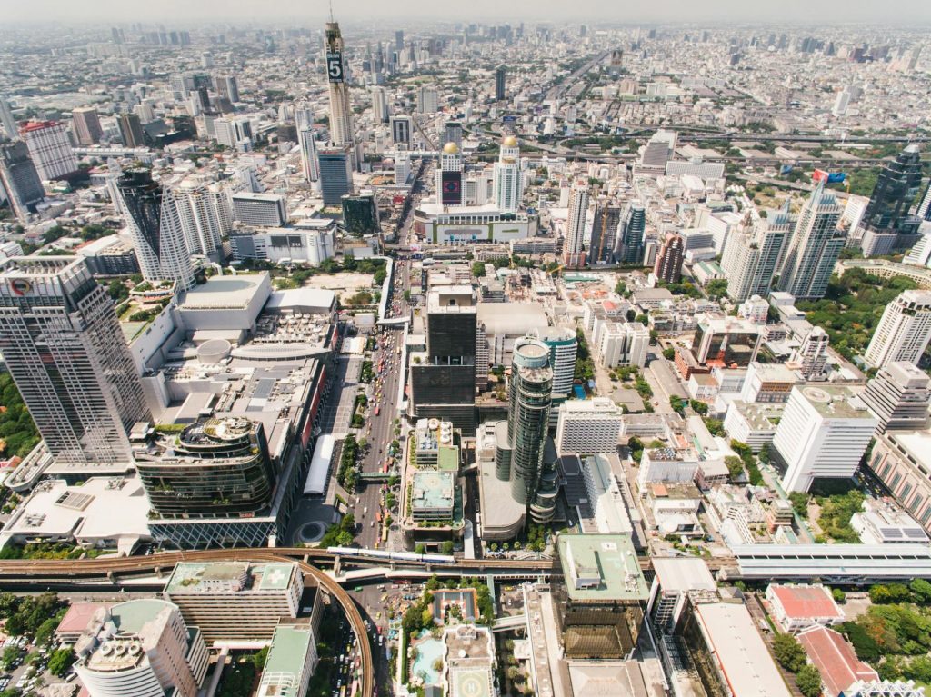 Explore Bangkok's dynamic urban landscape with this breathtaking aerial shot highlighting modern skyscrapers and busy streets.