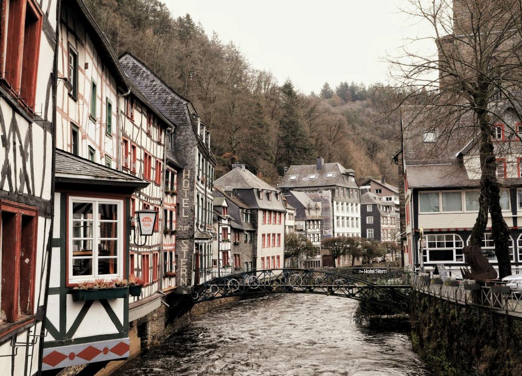 Picturesque half-timbered houses along the Rur River in Monschau, Germany, during fall.