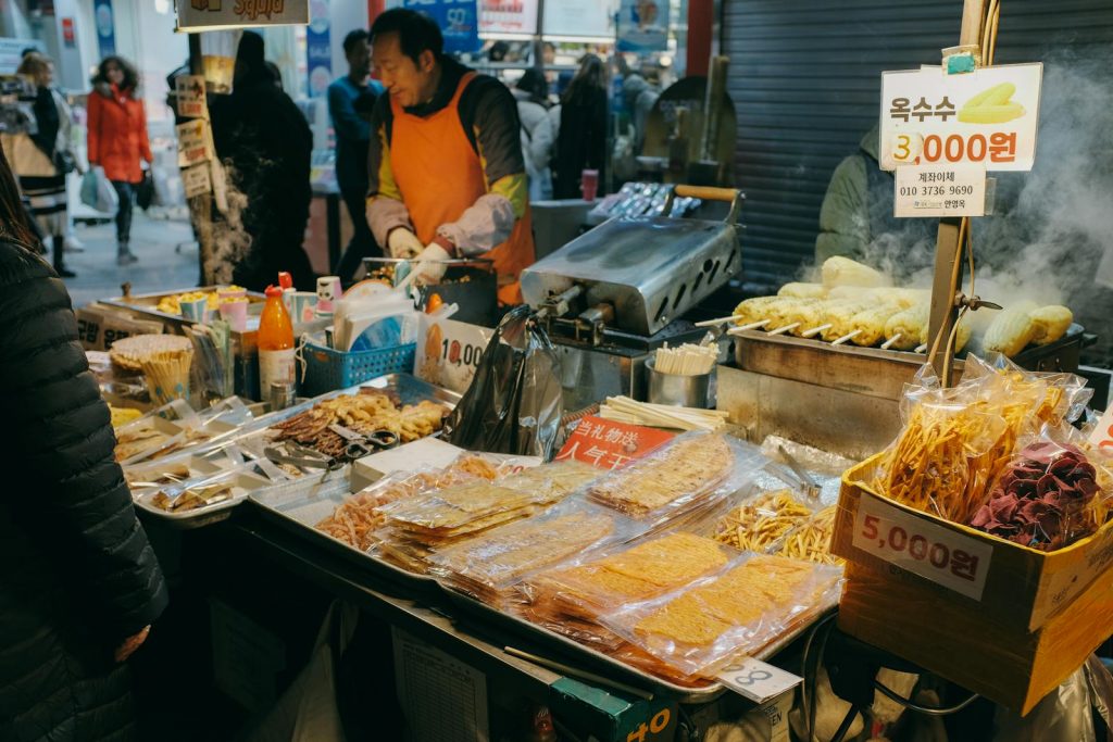 Colorful street food market in Seoul, showcasing local Korean snacks and the bustling urban environment.