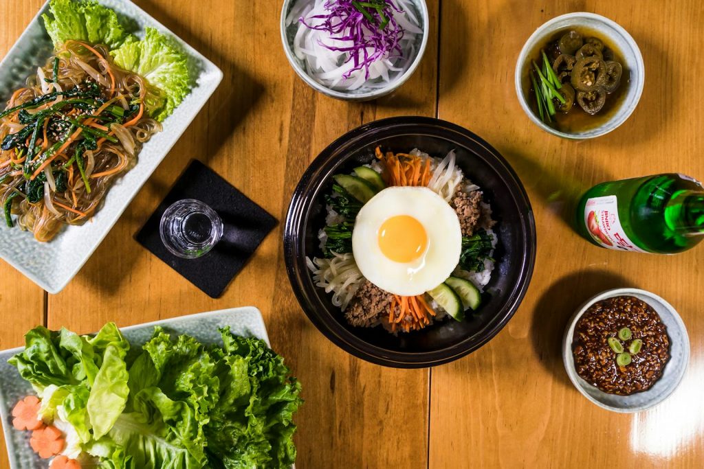 Authentic Korean meal featuring Bibimbap and Japchae, styled in a beautiful flat lay.