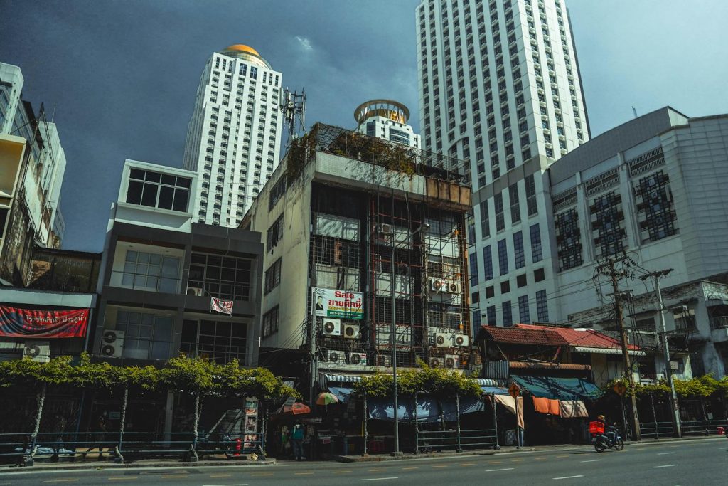 Street view of contrasting old and new architecture in Bangkok, Thailand.