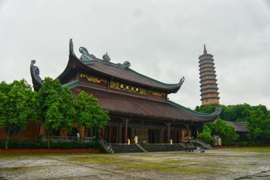 Explore the serene Bai Dinh Pagoda complex surrounded by lush greenery in Vietnam.