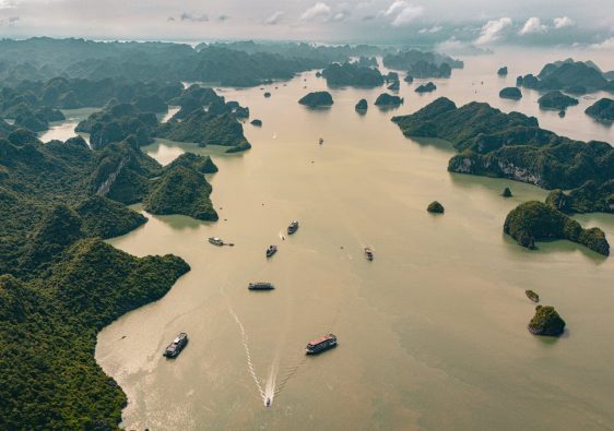 Aerial view capturing the stunning limestone islands and tranquil waters of Halong Bay, Vietnam.