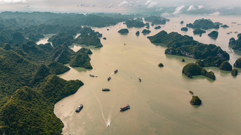 Aerial view capturing the stunning limestone islands and tranquil waters of Halong Bay, Vietnam.