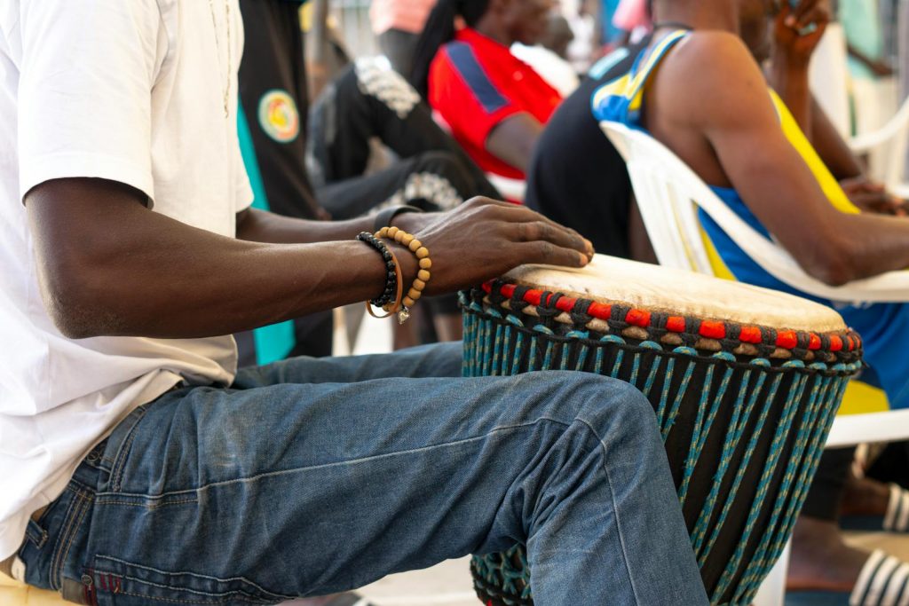 A street musician in Senegal playing a traditional African Djembe drum.
