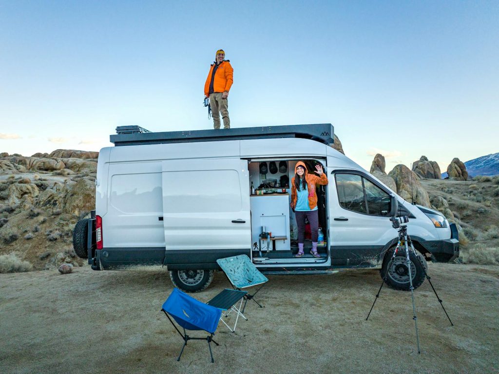 Couple enjoying van life amidst stunning rocky terrain, perfect for adventure seekers.