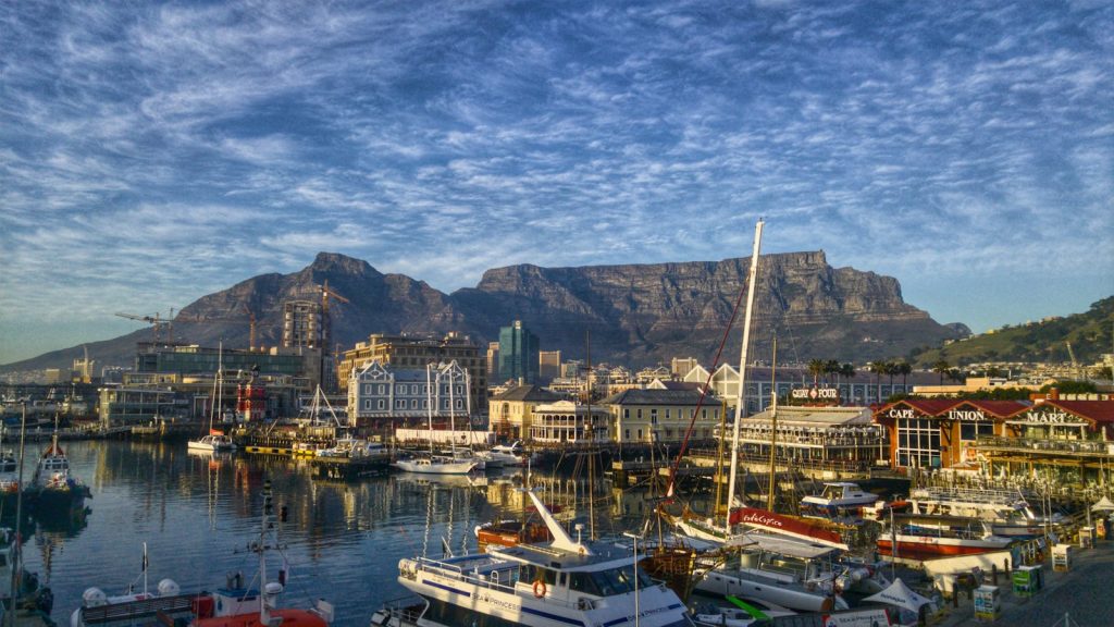 Stunning view of Cape Town harbor with boats and iconic Table Mountain backdrop.