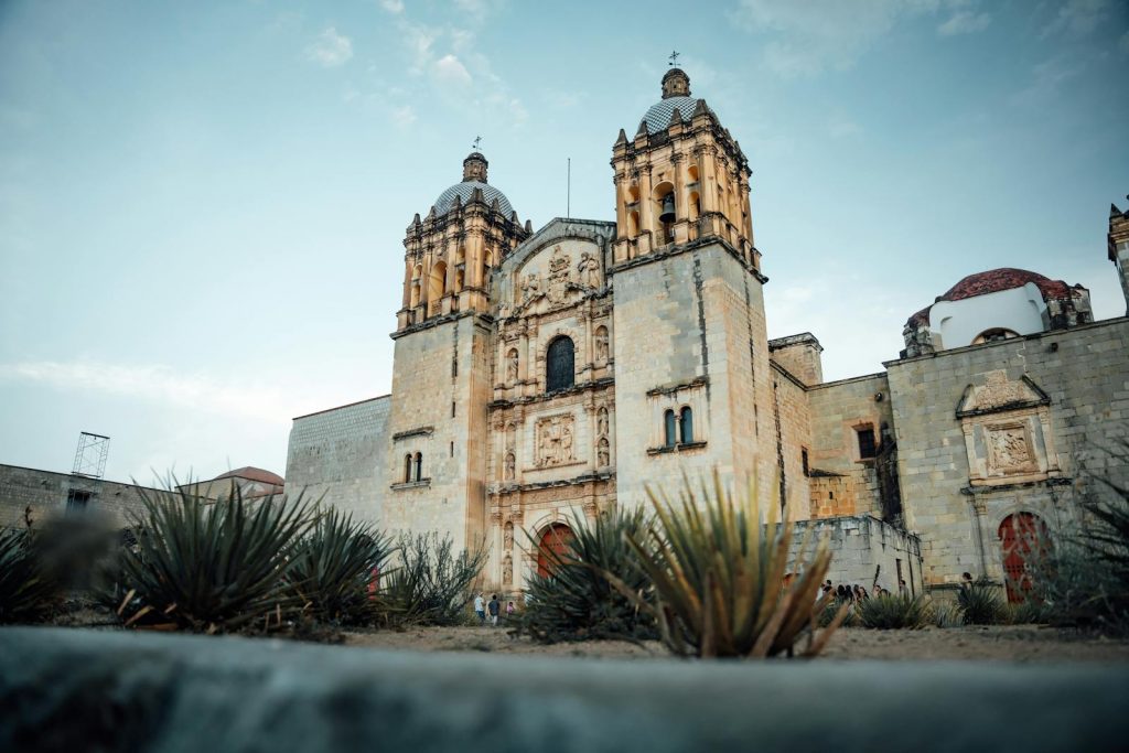 The Santo Domingo de Guzmán church captured with agave plants in the foreground, Oaxaca, Mexico.