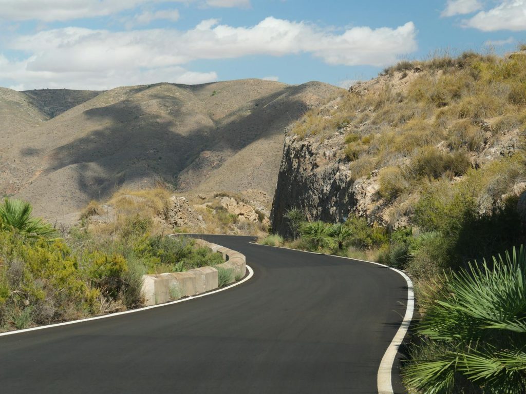 Discover the beauty of a winding road through the rugged, arid mountains, perfect for adventure seekers.