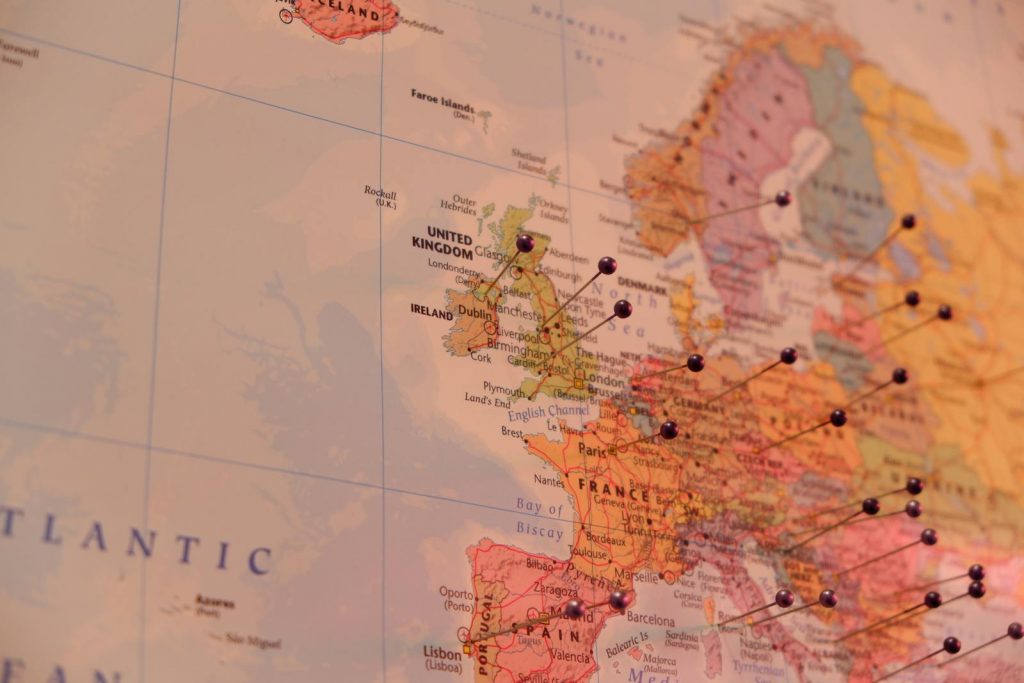 Close-up of a map with push pins marking countries in Europe, including Ireland and the UK.