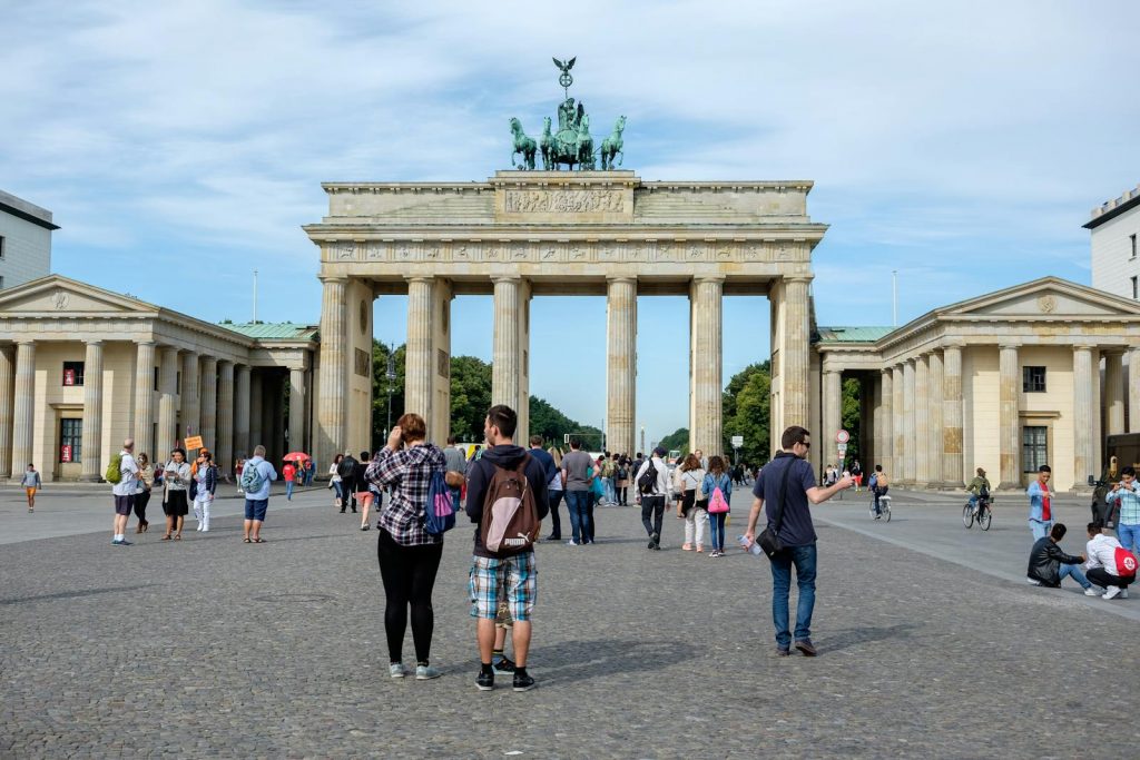 Visitors explore the iconic Brandenburg Gate in Berlin, Germany.
