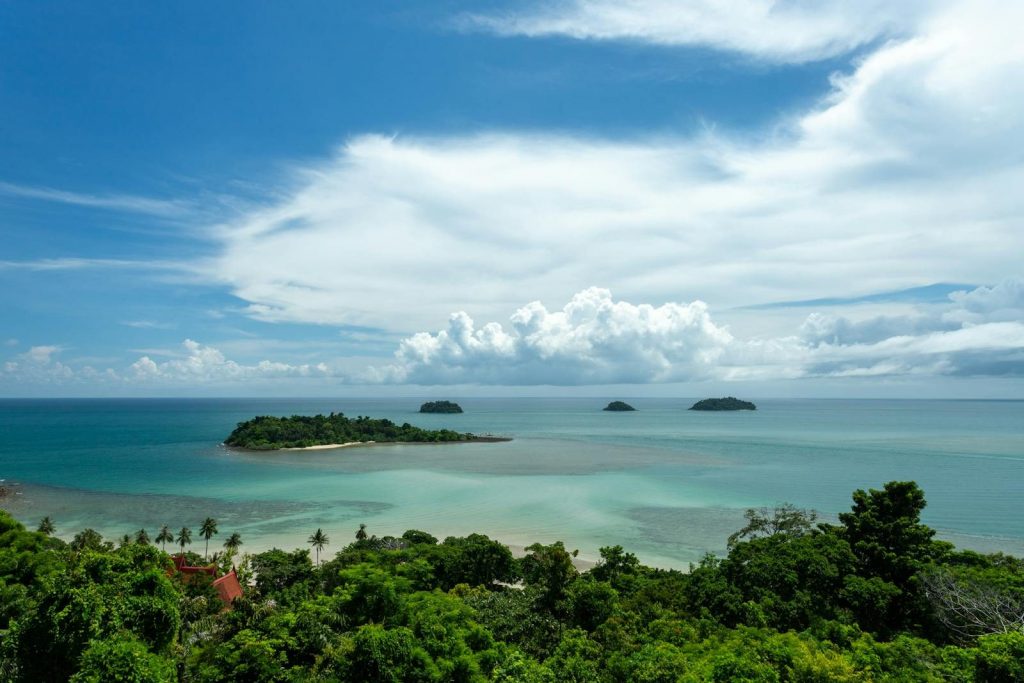 Breathtaking aerial view of tropical islands in the azure ocean under a bright sky.